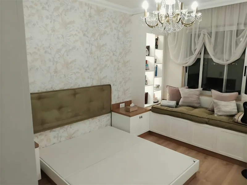 Bedroom with a window seat, cushions and curtains