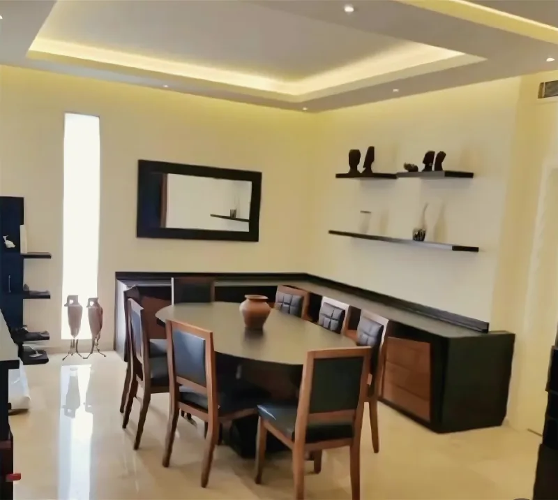Dining room under a gypsum ceiling with cove lighting