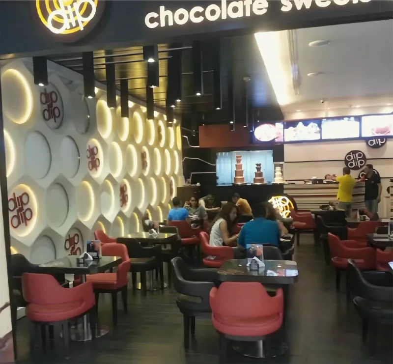 Dip n Dip café interior with red chairs, fitted out by Yamout