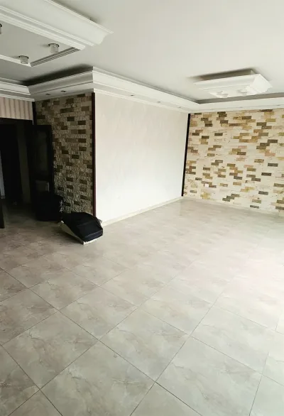 Tiled floor and stone-clad wall