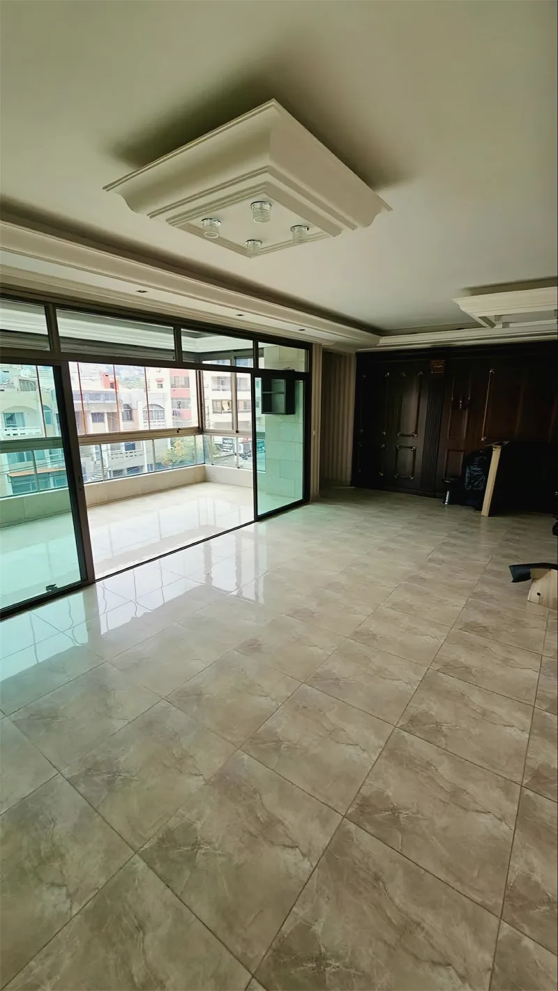 Large aluminum and glass sliding doors to a balcony