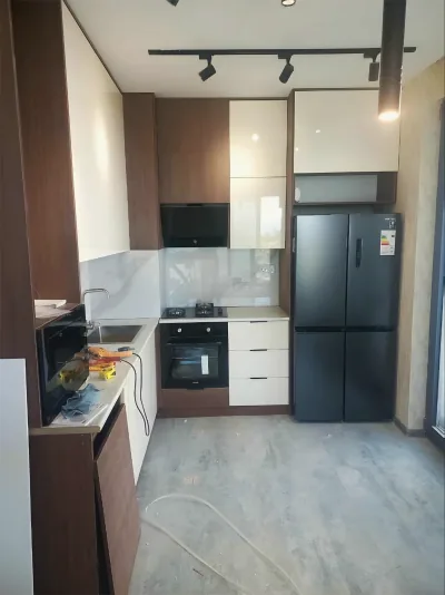 Kitchen being fitted with its sink and appliances