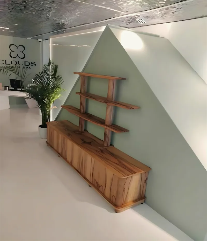 Wooden console and open shelves fitted under a sloping wall, by Yamout